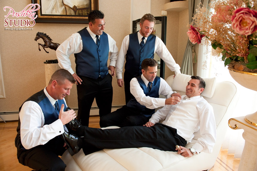 Groom's best man and friends helping him prepare for the big day