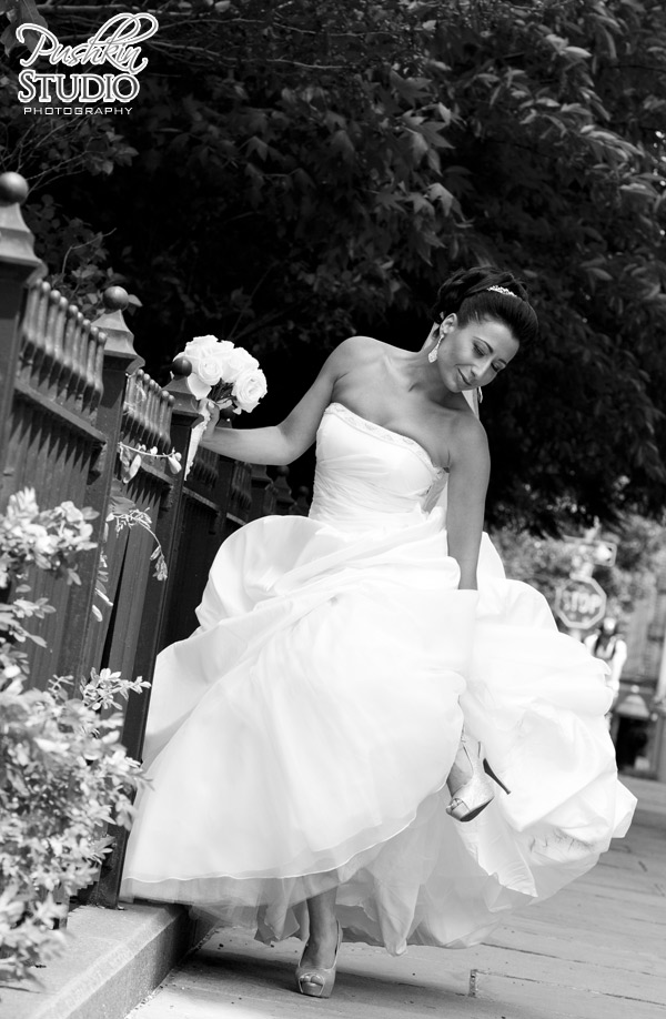 Bride is fixing her shoe after a long walk