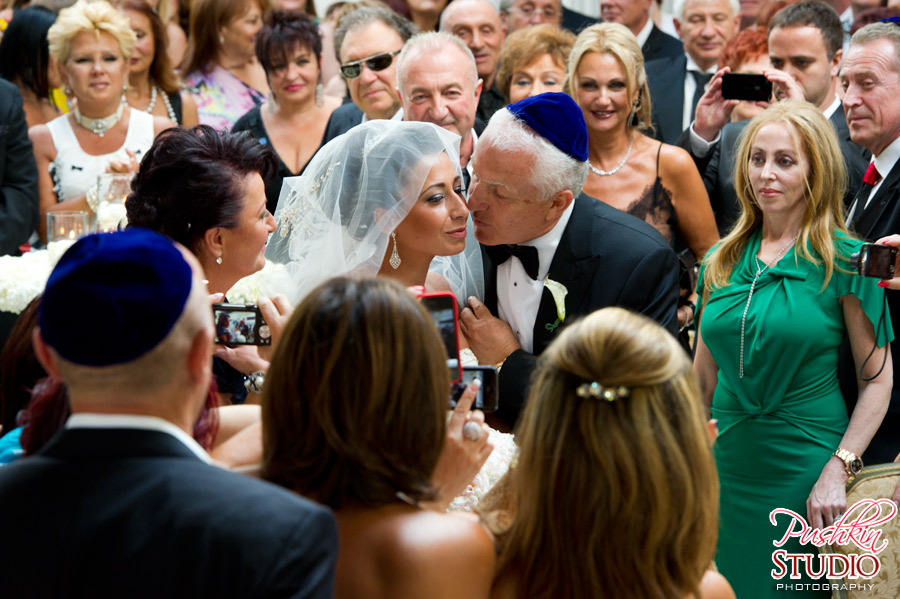 Mother, father, and bride walking down the isle